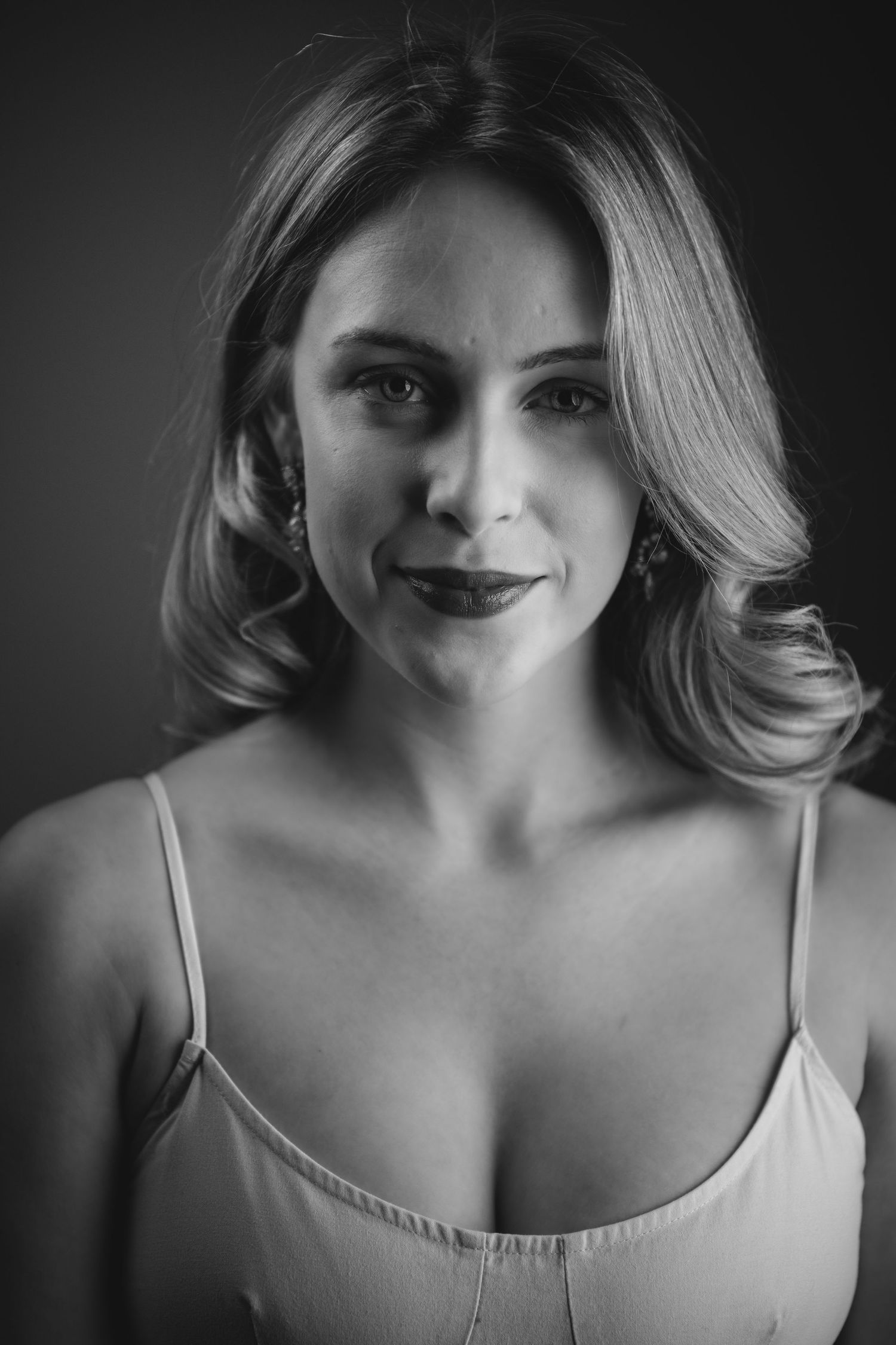 A series of black and white portraits showing close-up views of shoulders and neckline in dramatic lighting.