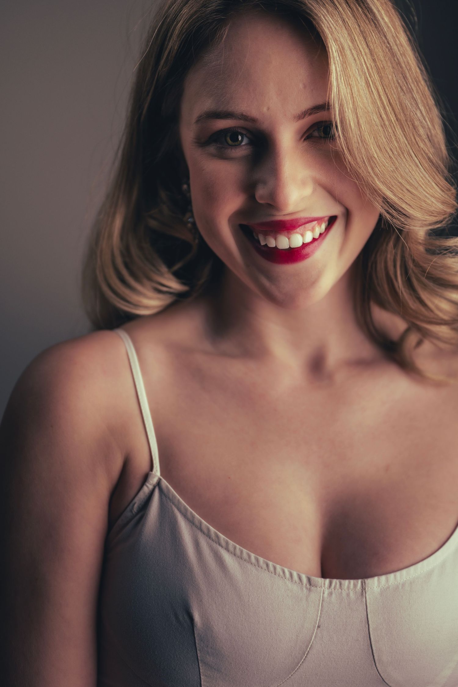 Close-up portrait series showing joyful expressions in neutral tones.