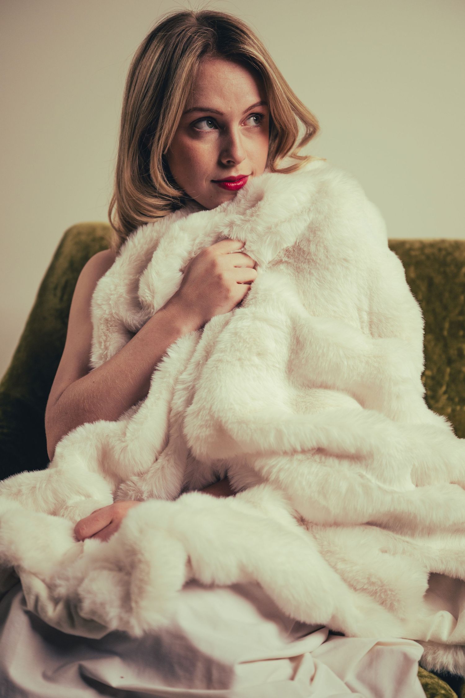 Artistic photo series showing a person reclining with a plush white fur blanket in romantic boudoir style.