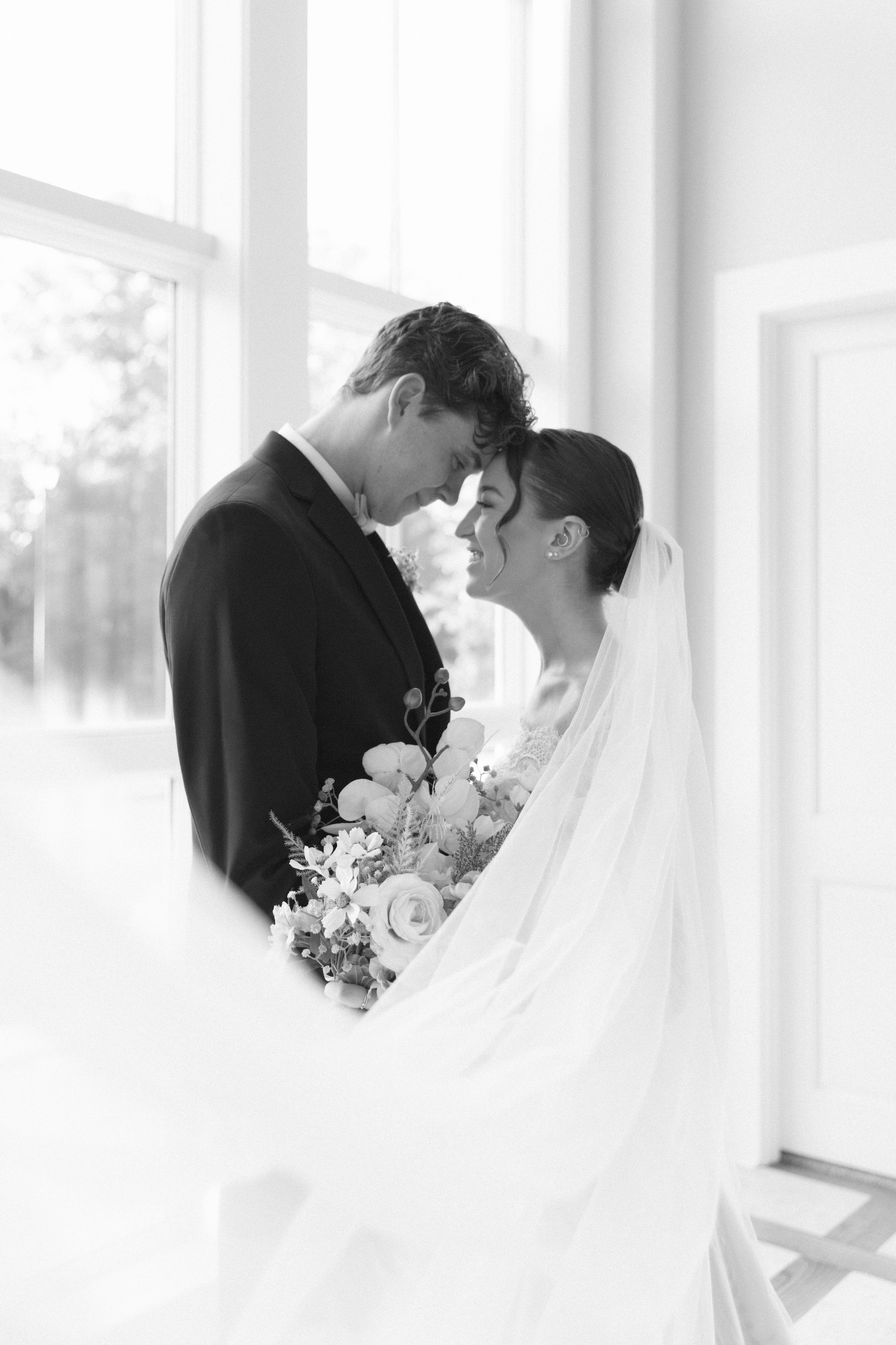 A romantic black and white wedding photo series showing tender moments between a bride and groom.