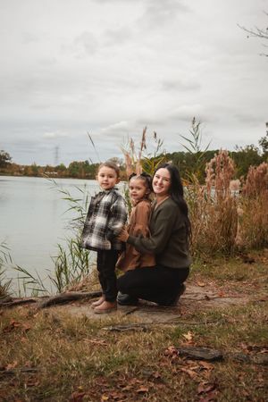 A heartwarming autumn scene by the lake with tall grass and overcast skies in the background.