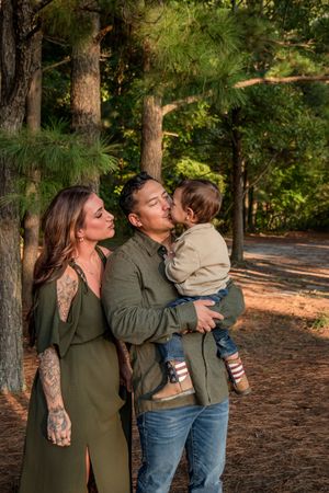 A series of candid outdoor photos showing affectionate moments between family members in a wooded setting.