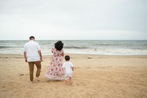 A series of romantic beach photos showing a couple walking together along the sandy shoreline at sunset.