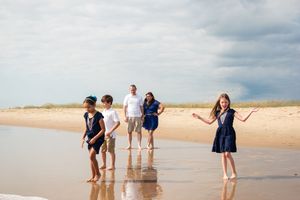 Family enjoying a fun day together at the beach during golden hour.