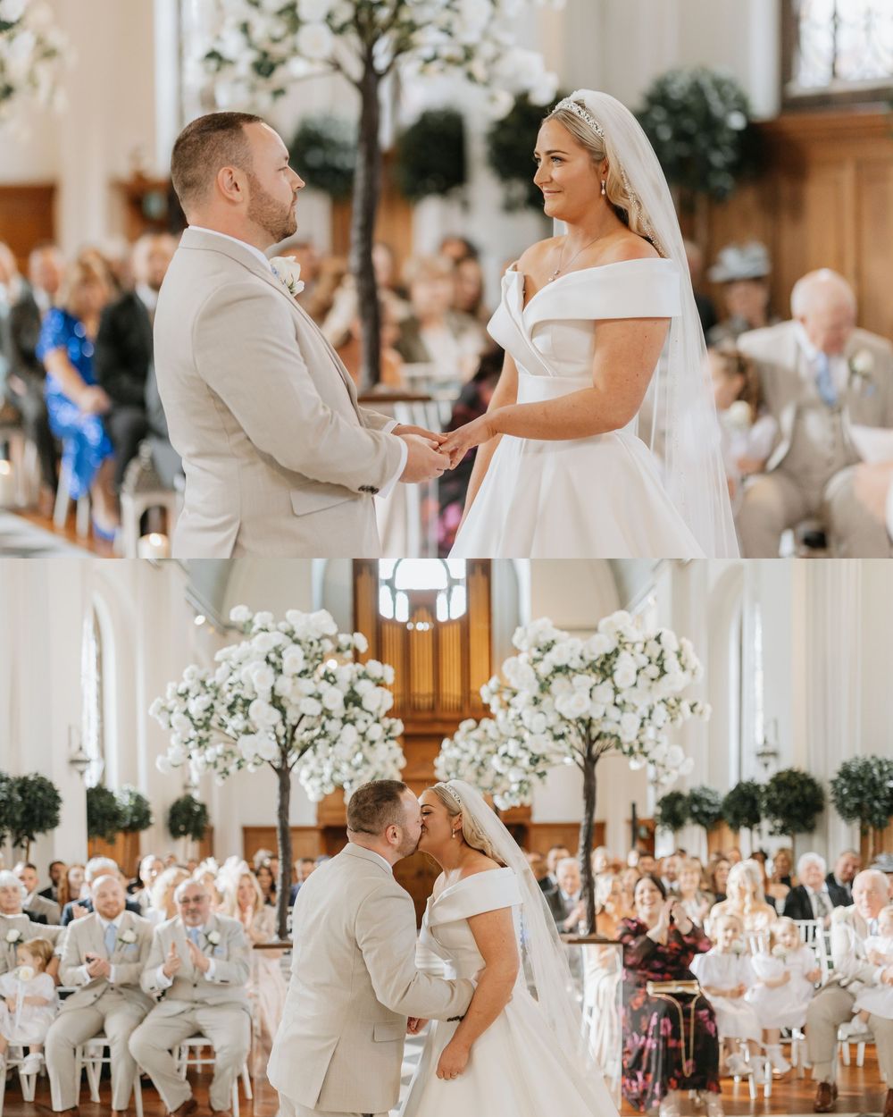 A romantic wedding ceremony in a light-filled church with white floral decorations and guests watching from the pews.
