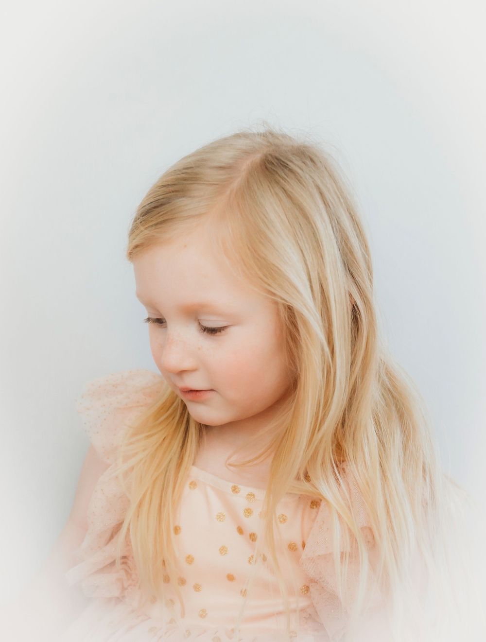 A series of profile portraits showing a young child with blonde hair against a soft white background.