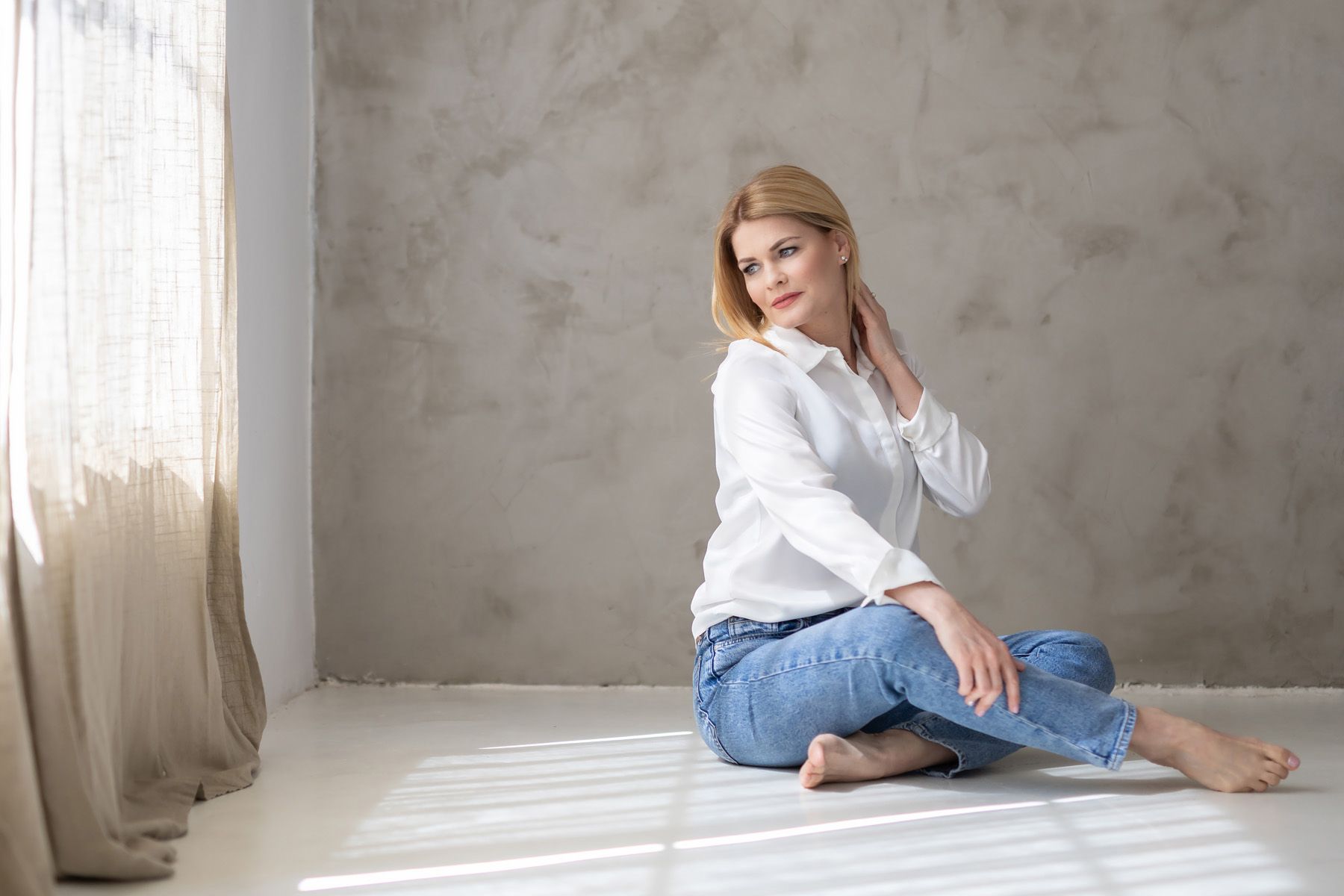 A collection of four similar portrait photos against a textured gray wall with minimalist styling.