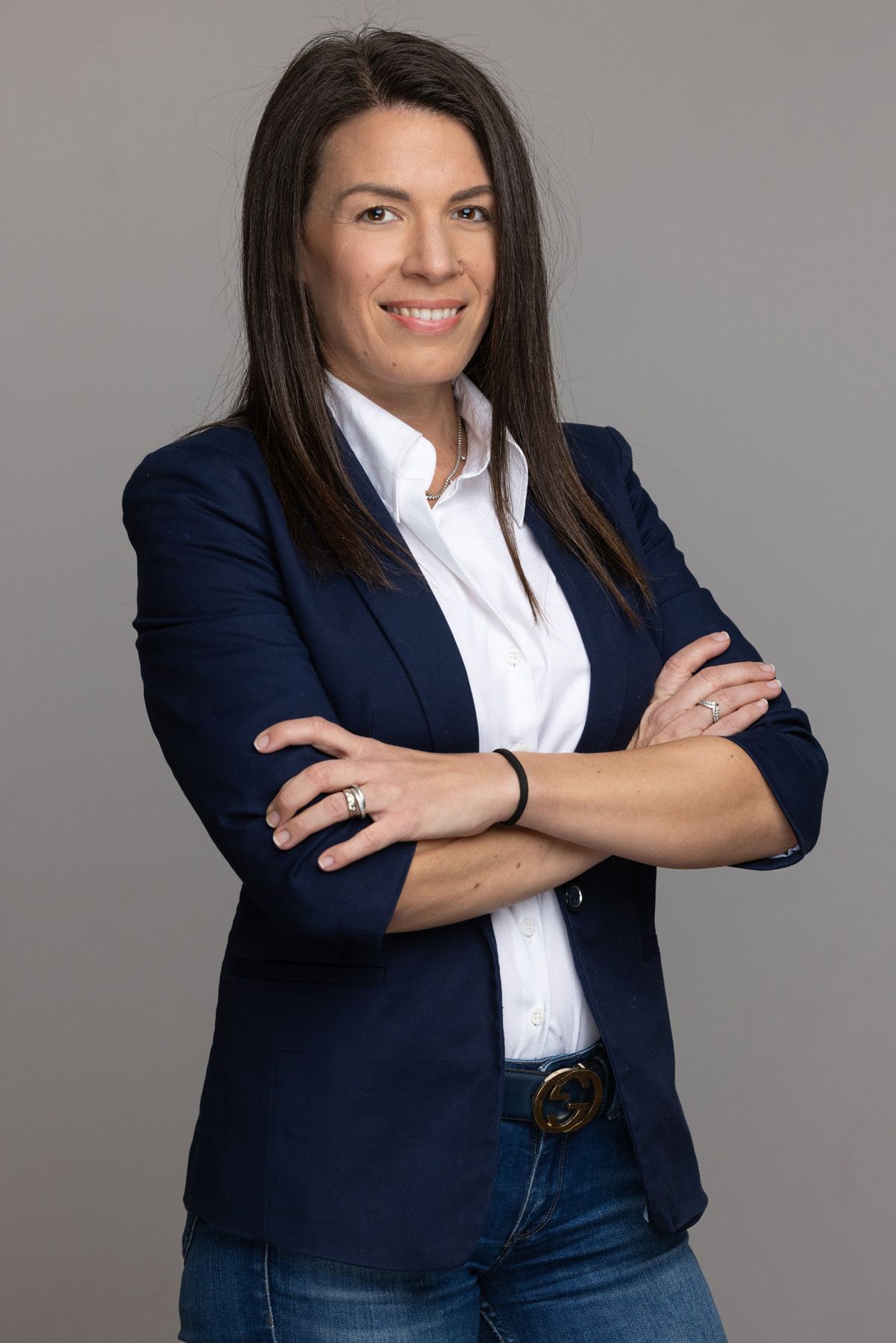 Professional portrait series of a person in a navy blazer and white button-down shirt against a gray background.