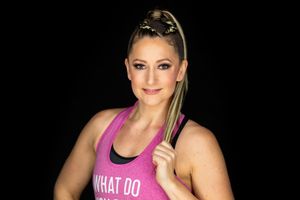 Athletic person in pink workout top and black pants demonstrates fitness poses against dark background.