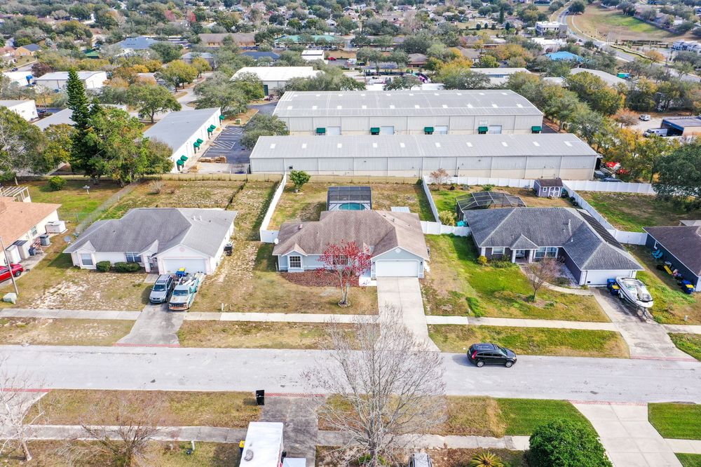 Aerial view of residential neighborhood showing rooftops and property layouts.