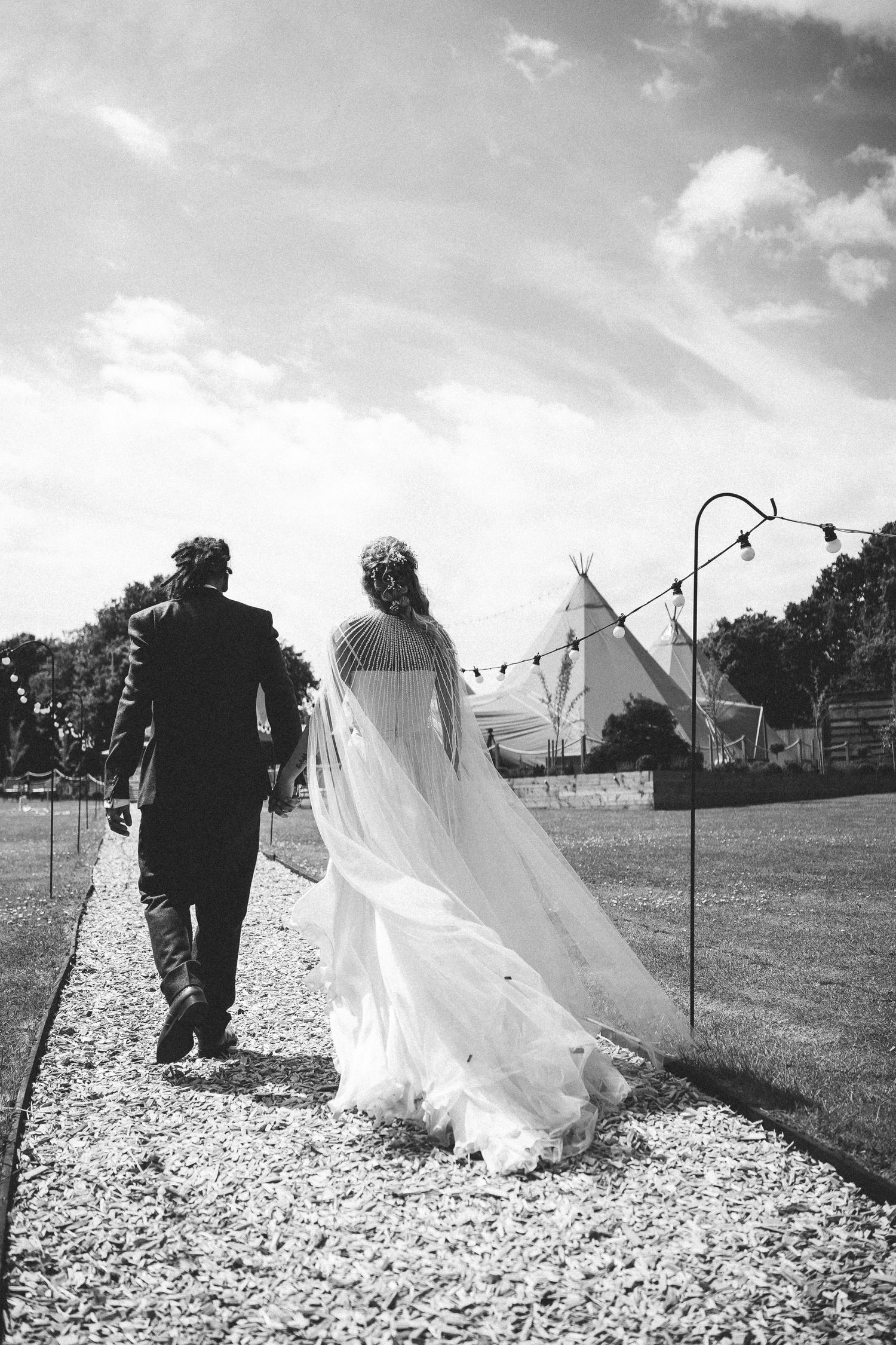 A black and white photo series shows flowing white fabric draped against outdoor clotheslines on a sunny day.