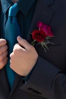 groom boutonniere with two red roses