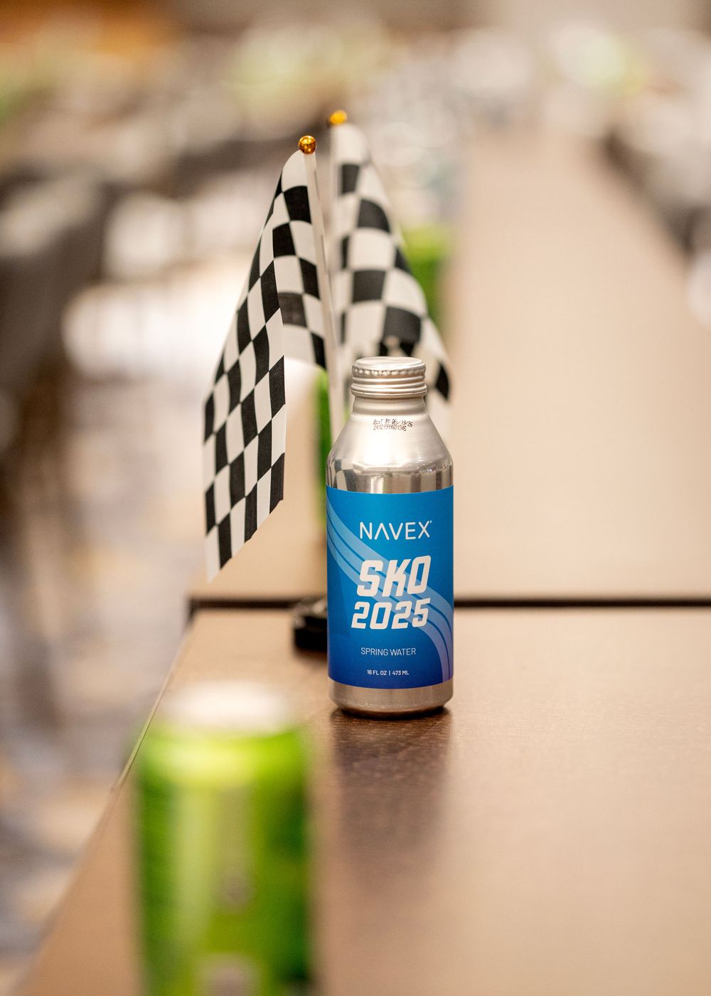 NAVEX branded drink bottle with racing checkered flags on display.