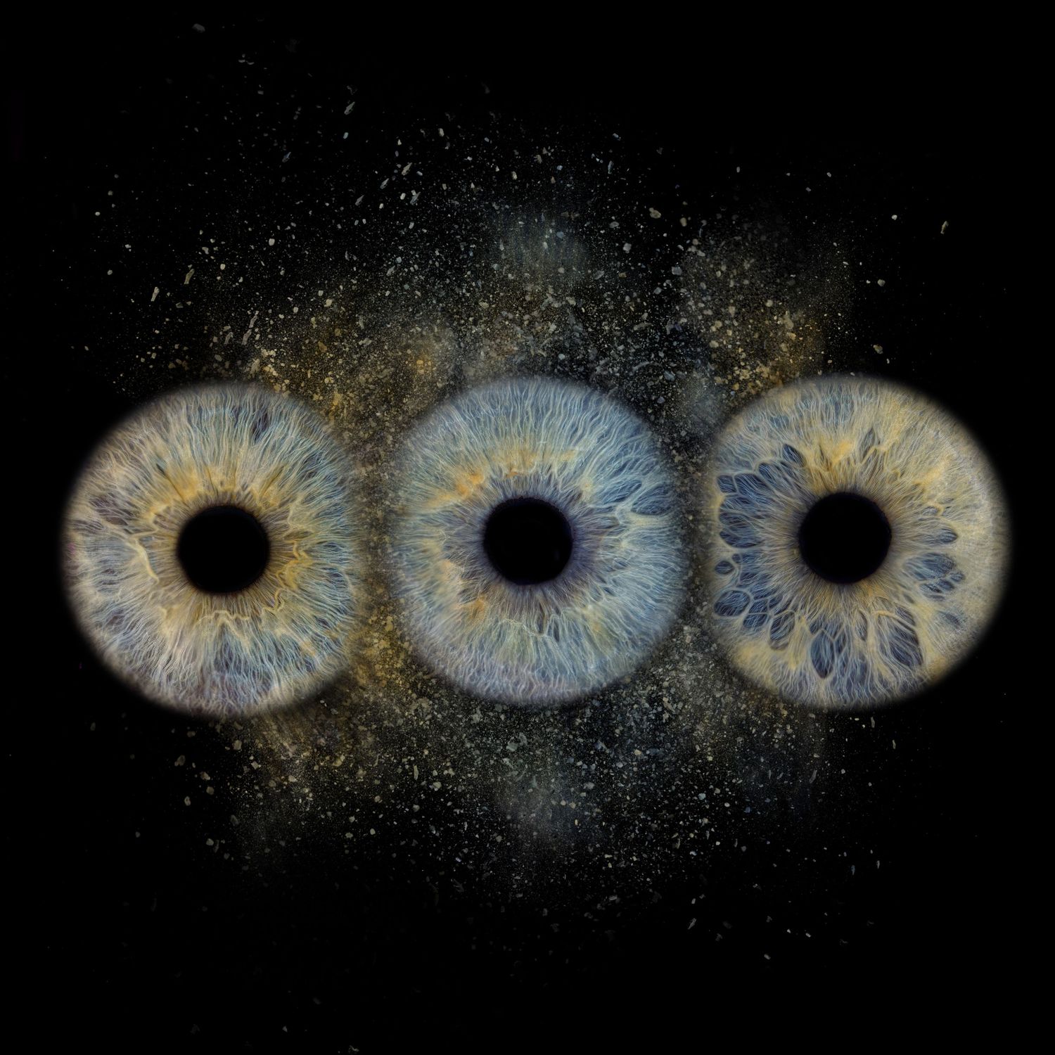 Three blue iris patterns aligned horizontally against a dark background with cosmic dust effects.
