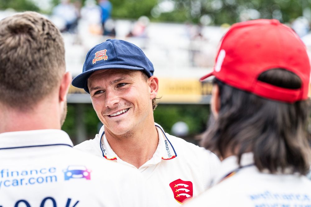 Motorsport event participants having a friendly conversation during a competition.