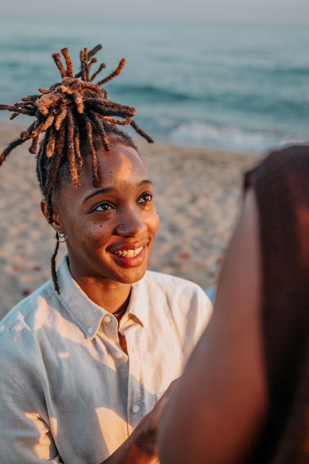 Couple hugging after the proposal on beach