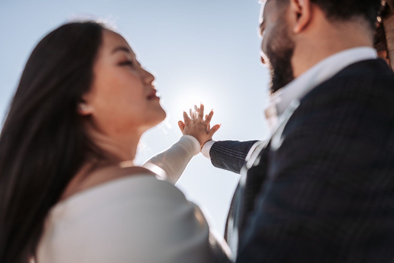 A romantic photoshoot sequence of a couple in wedding attire sharing intimate moments against a bright background.