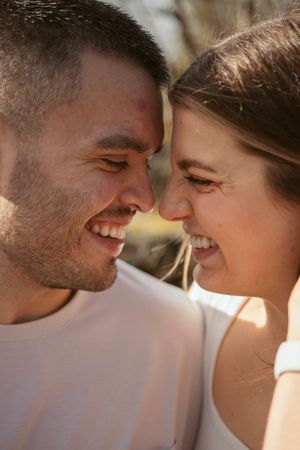 Close-up sequence of a couple's faces nearly touching in warm sunlight.