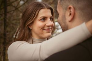 Close-up portrait of couple sharing tender moment in autumn setting.
