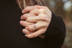 Multiple close-up shots of hands clasped together showing engagement ring details.