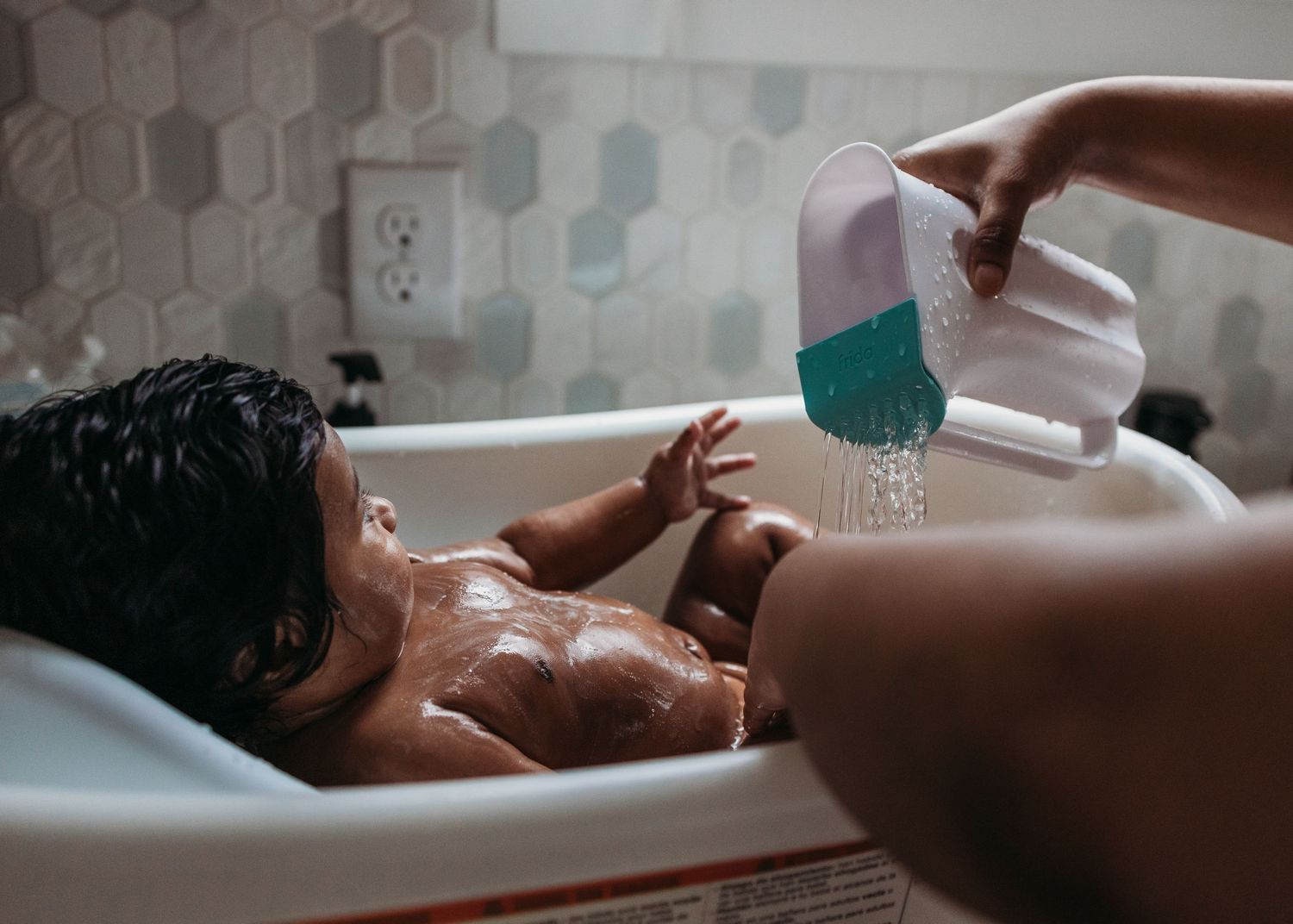 A figure relaxes in a bathtub filled with milky white bath water creating a serene and peaceful spa-like atmosphere.