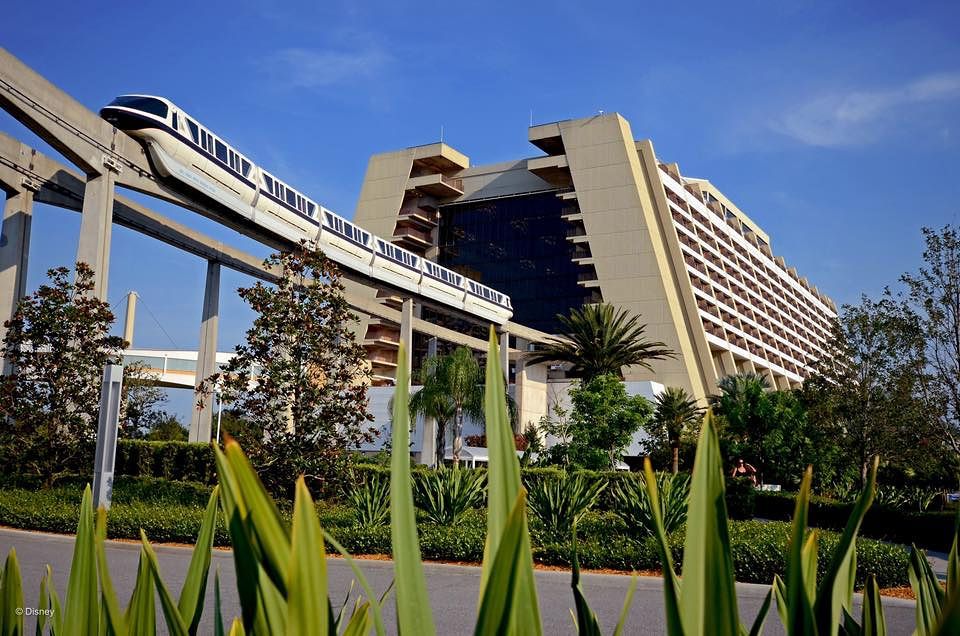 Contemporary Resort hotel building with monorail track in foreground against blue sky.