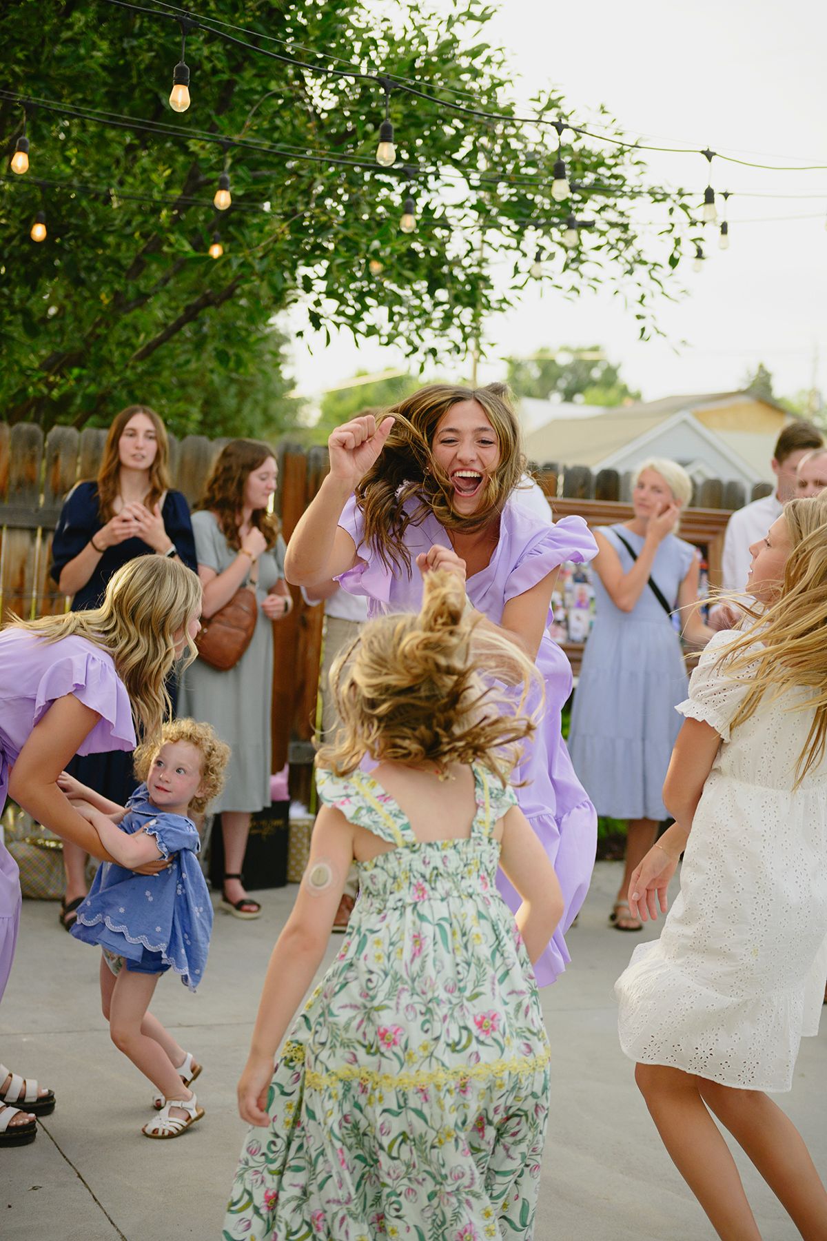 Blackfoot wedding photographer ShutterGirl dancing at backyard wedding in Blackfoot idaho