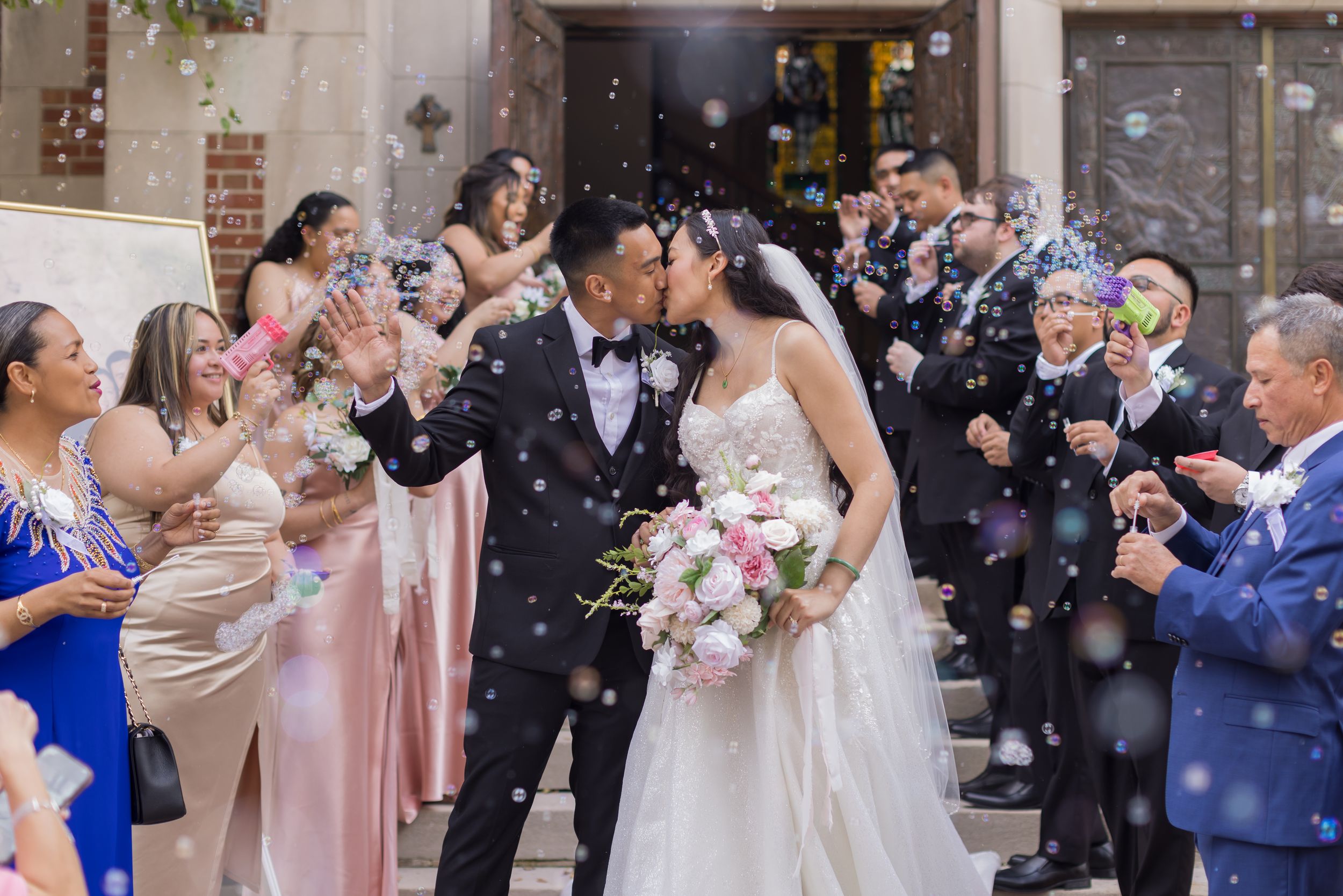 Joyful guests shower couple with confetti after their wedding ceremony at a historic brick venue.