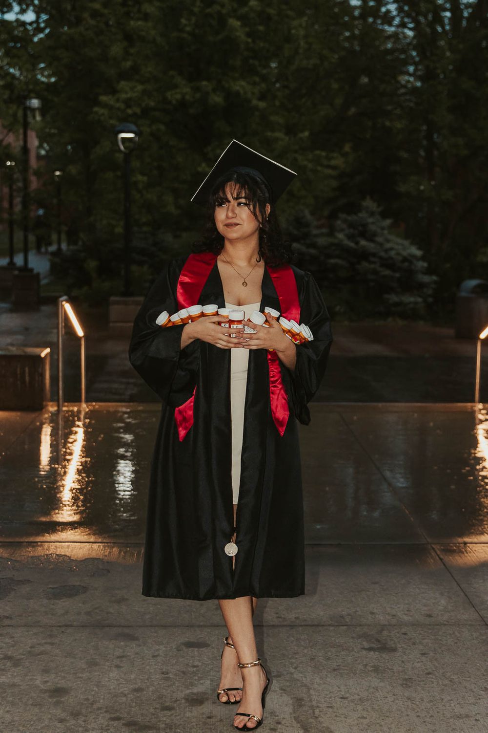 College senior at Eastern Washington University holding prescription bottles to celebrate mental health journey
