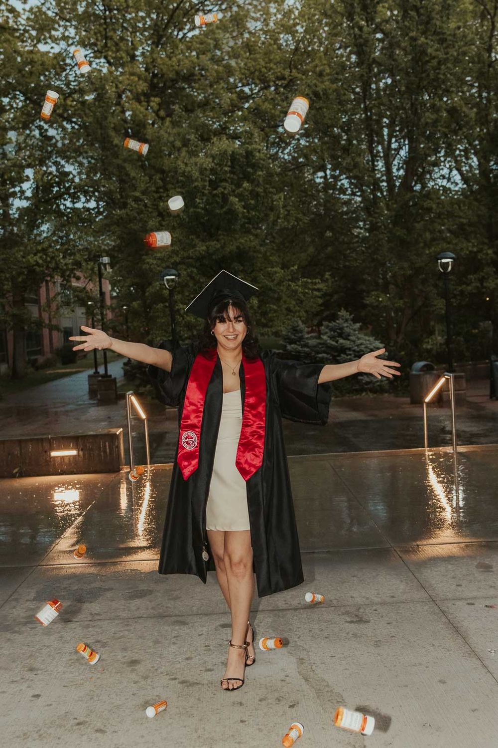 College senior at Eastern Washington University holding prescription bottles to celebrate mental health journey