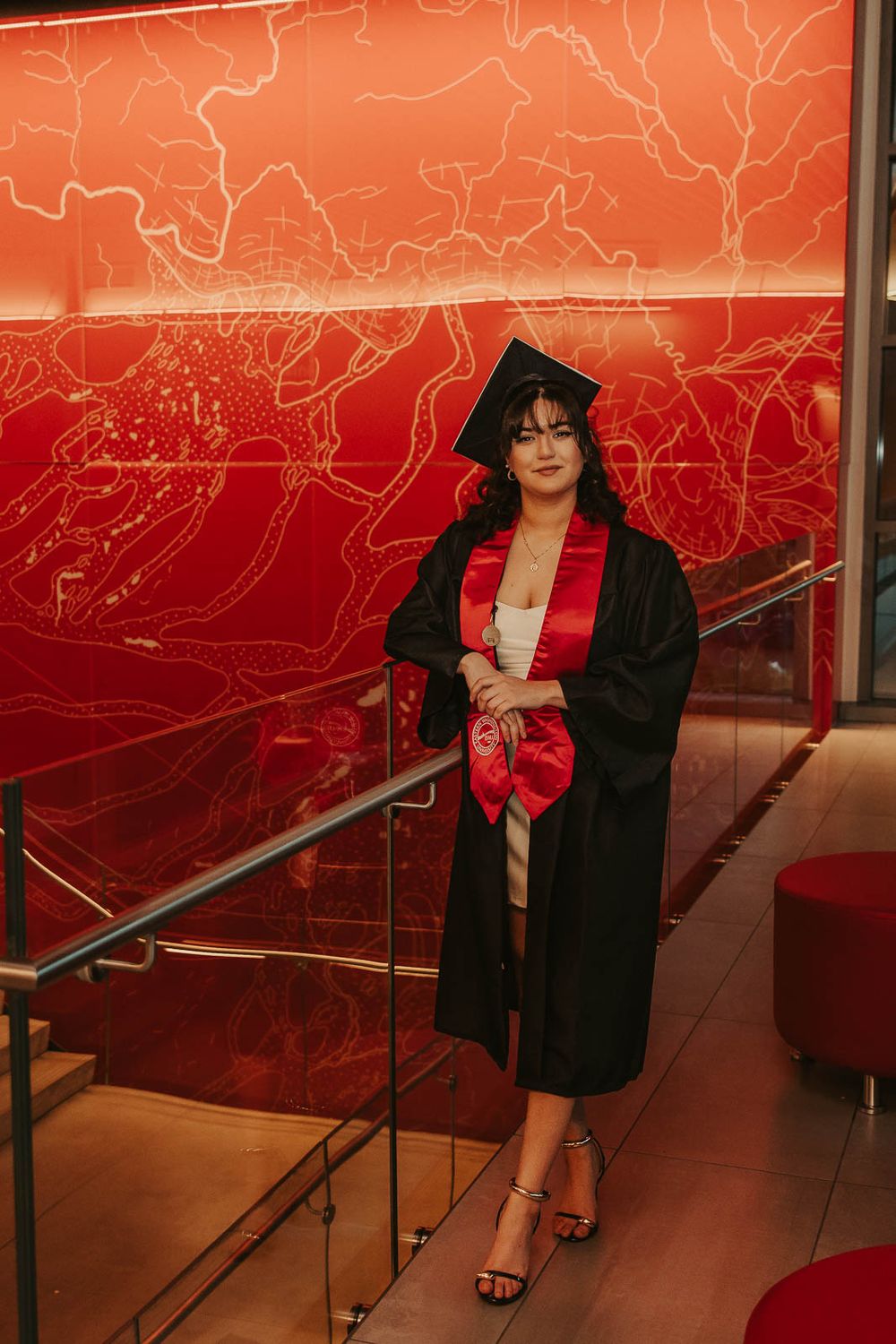 Graduation photos on EWU campus in Cheney, WA with emotional storytelling elements inside of Eastern Washington University PUB