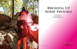 Fashion editorial spread featuring red smoke effects and gothic styling against rocky backdrop.