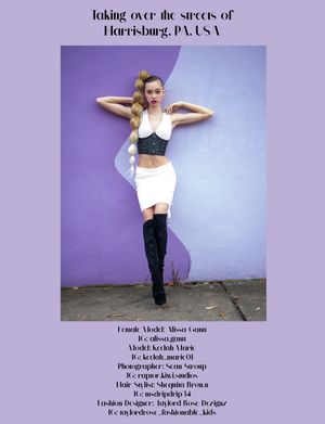Model in white crop top and boots poses against purple wall in Harrisburg PA photoshoot.