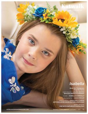 A floral crown with bright yellow sunflowers and blue roses adorns the image against a light colored background.
