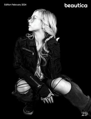 High contrast black and white fashion photo featuring model in denim with ripped jeans.