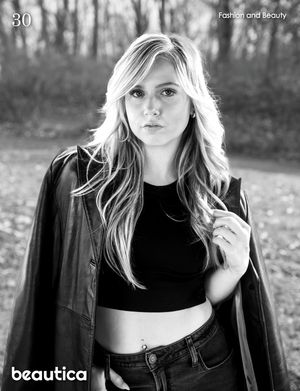 Black and white outdoor fashion portrait featuring casual style with a leather jacket.