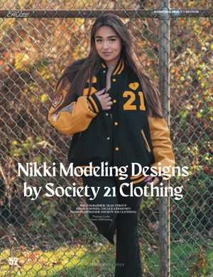 Fashion advertisement showing varsity jacket design against chain link fence in autumn setting.