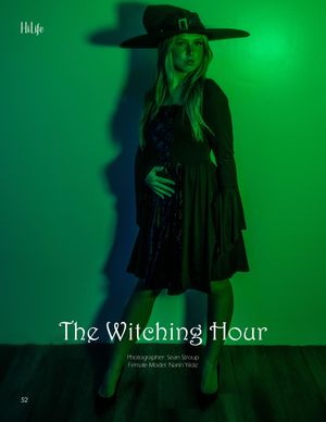 Atmospheric witch-themed fashion photo with green lighting and black dress costume.