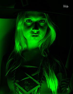 Dramatic close-up portrait with ethereal green lighting creating a supernatural mood.