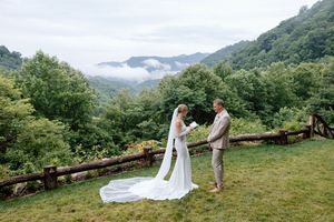 Couple shares a intimate moment on a misty mountain overlook during their wedding.