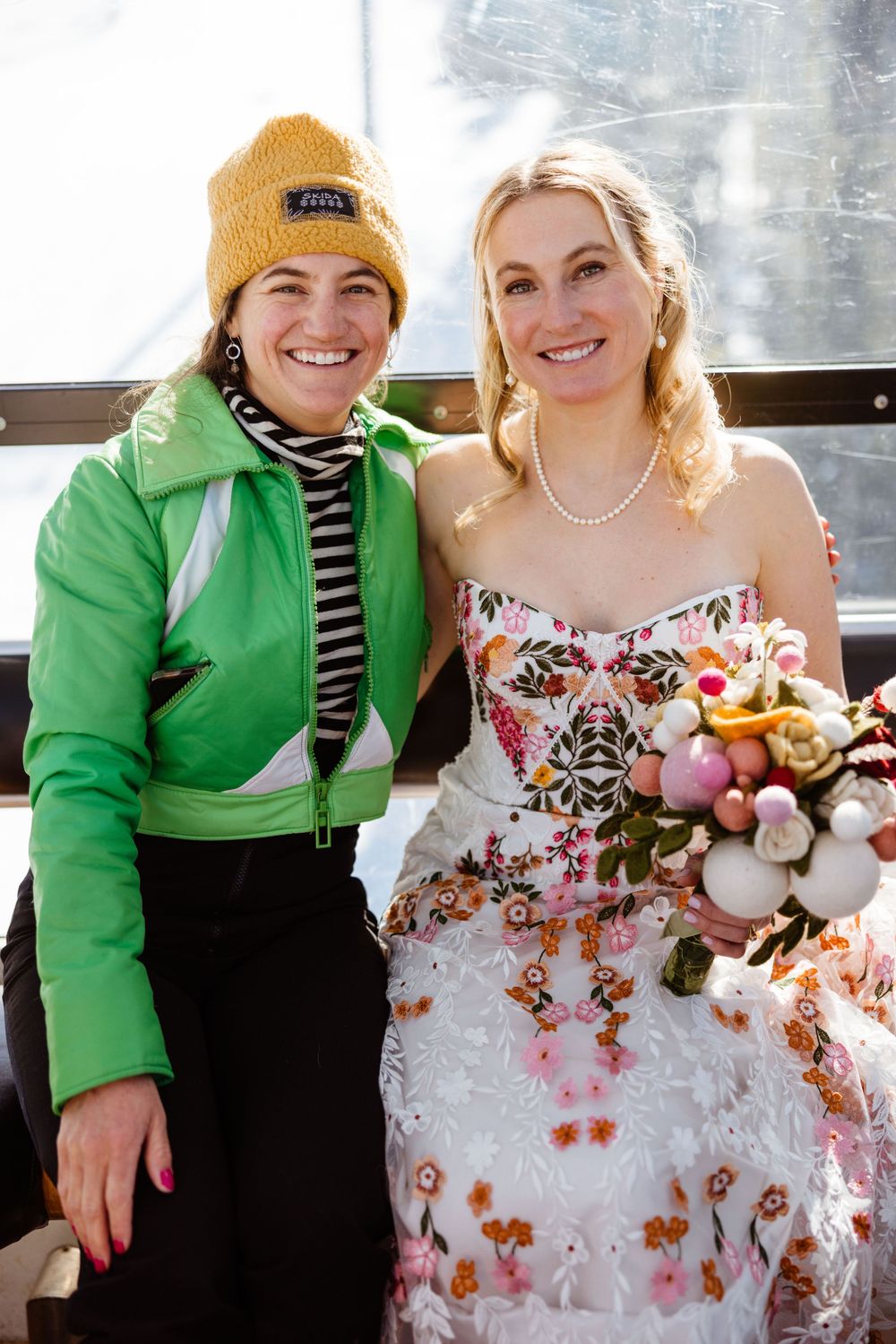 Wedding photos showing a person in a green jacket posing with someone in a floral dress.