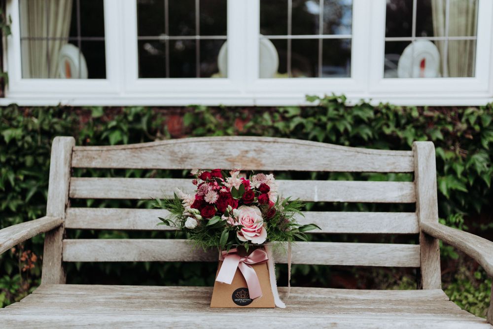 Wedding photography detail shot of flowers on bench outside brides home in Yorkshire