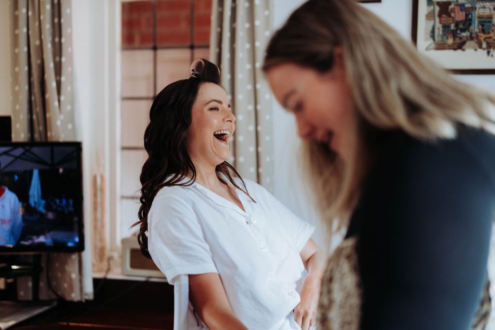 Bride smiling and laughing during bridal prep at home in Yorkshire