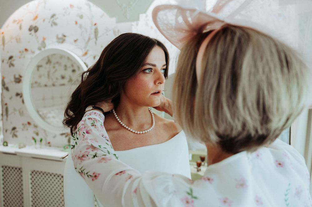 Yorkshire wedding photographer captures beautiful moment between bride and mother of bride during bridal preparations in Yorkshire.