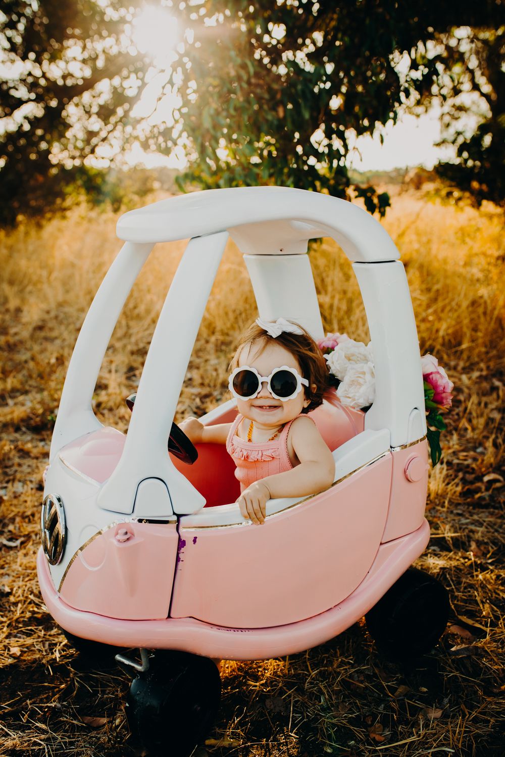 A toy car adventure in a pink and white cozy coupe at golden hour.