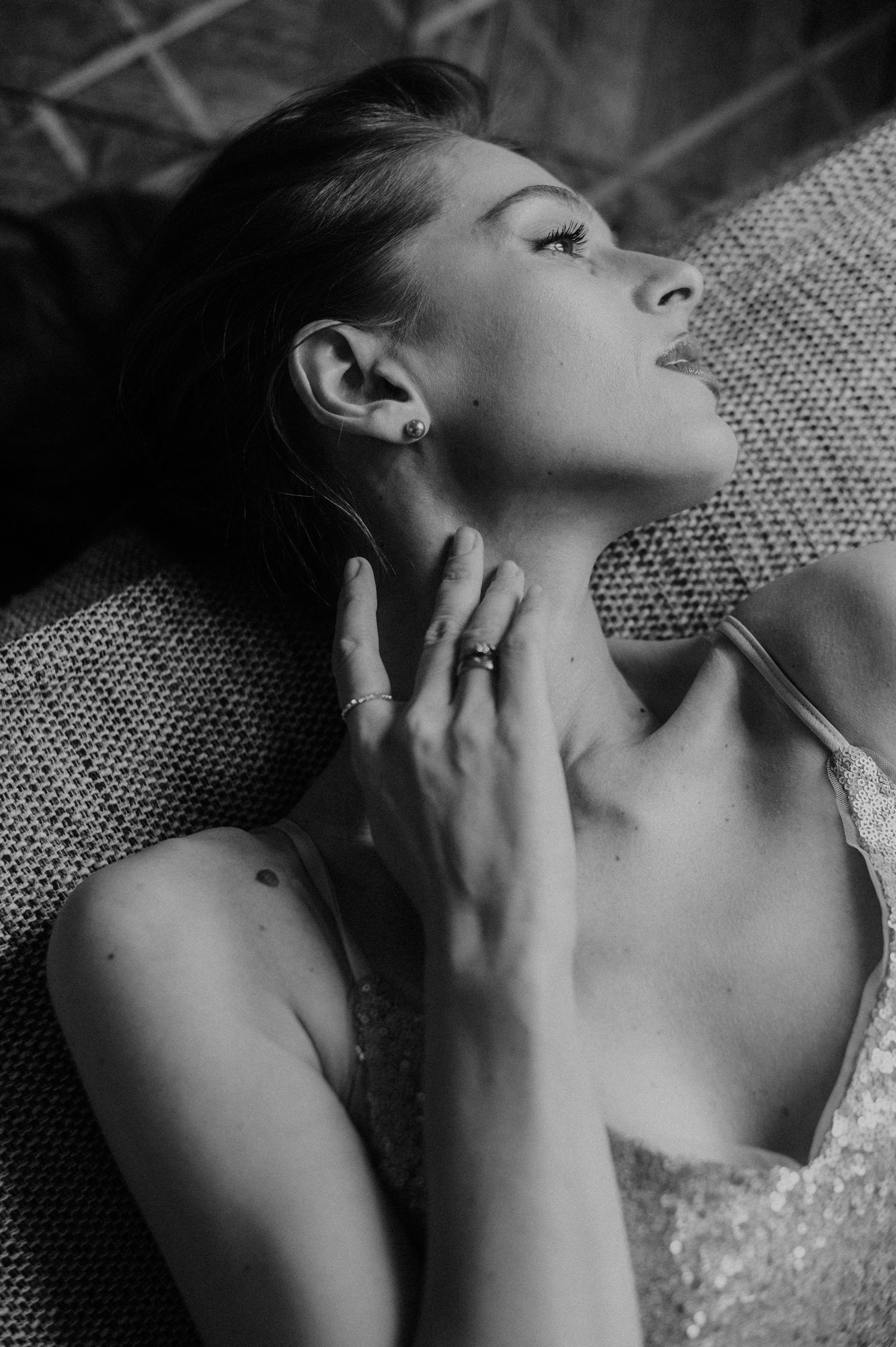 Dramatic black and white portrait showcasing elegant pose and sparkly formal attire.