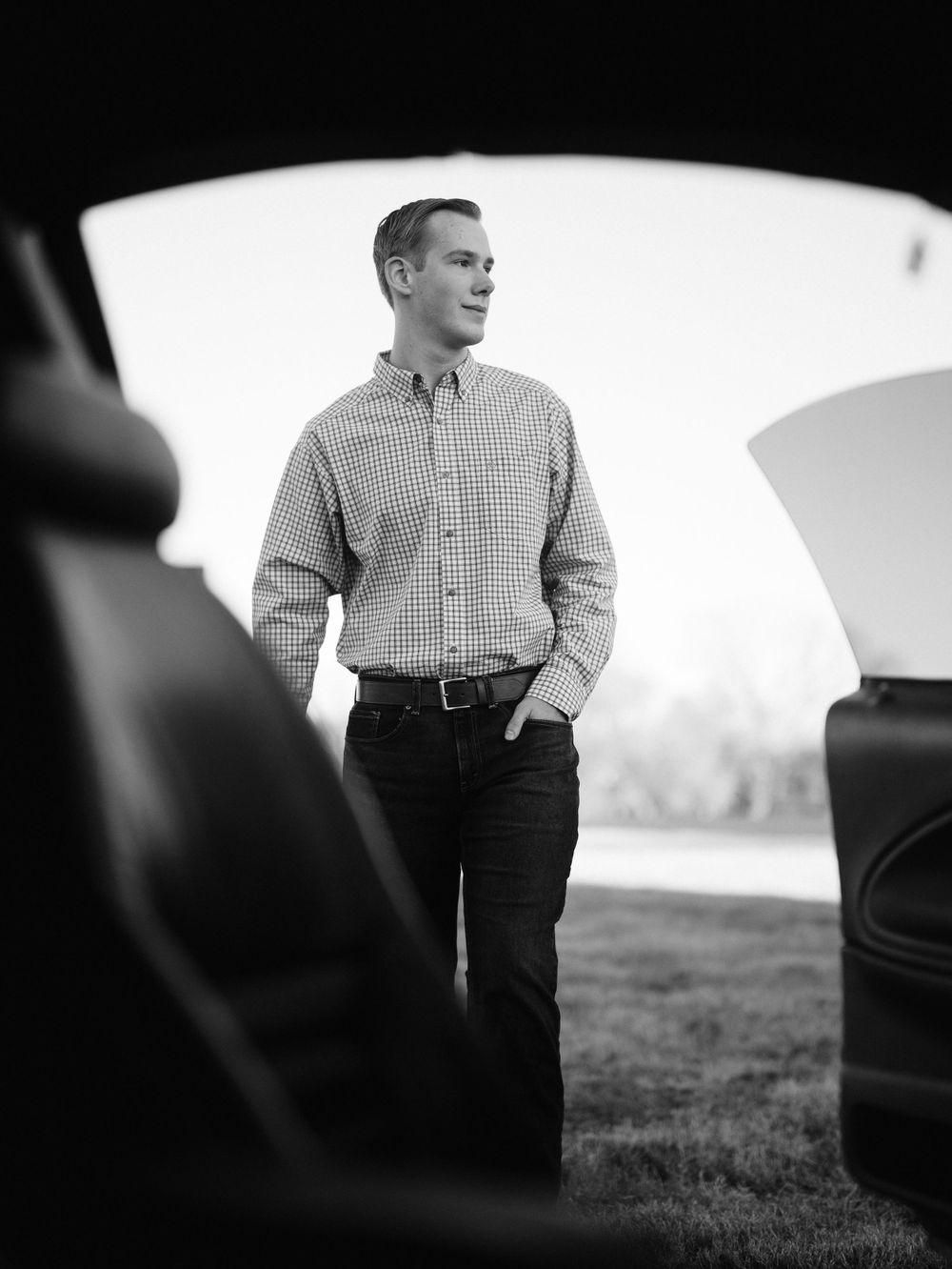 Black and white artistic photo taken through car window showing clean lines of vehicle.