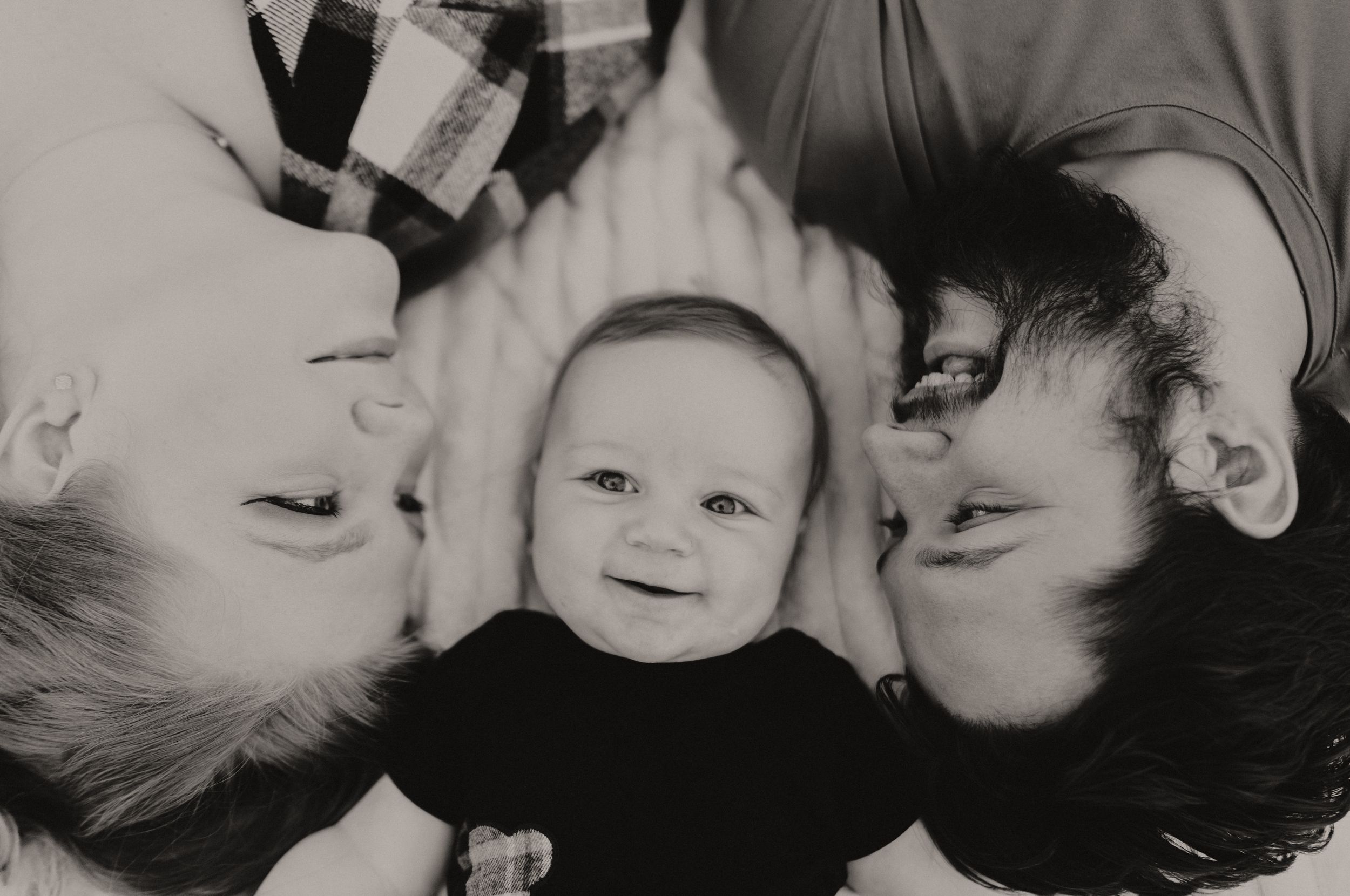 Black and white close-up portrait of a family sharing tender moments together.