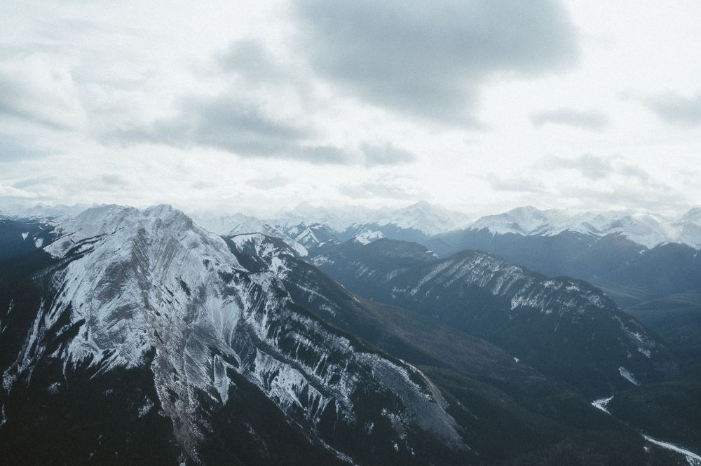 Aerial view of snow-covered mountain ranges stretching into the distance.