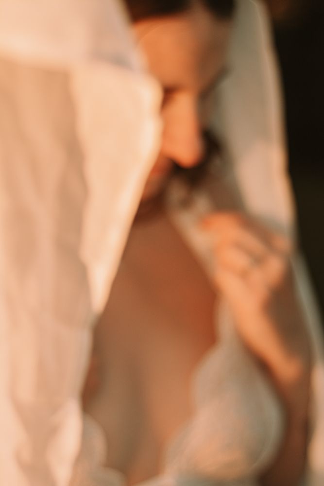 Abstract blurred portrait through sheer fabric in soft warm tones.